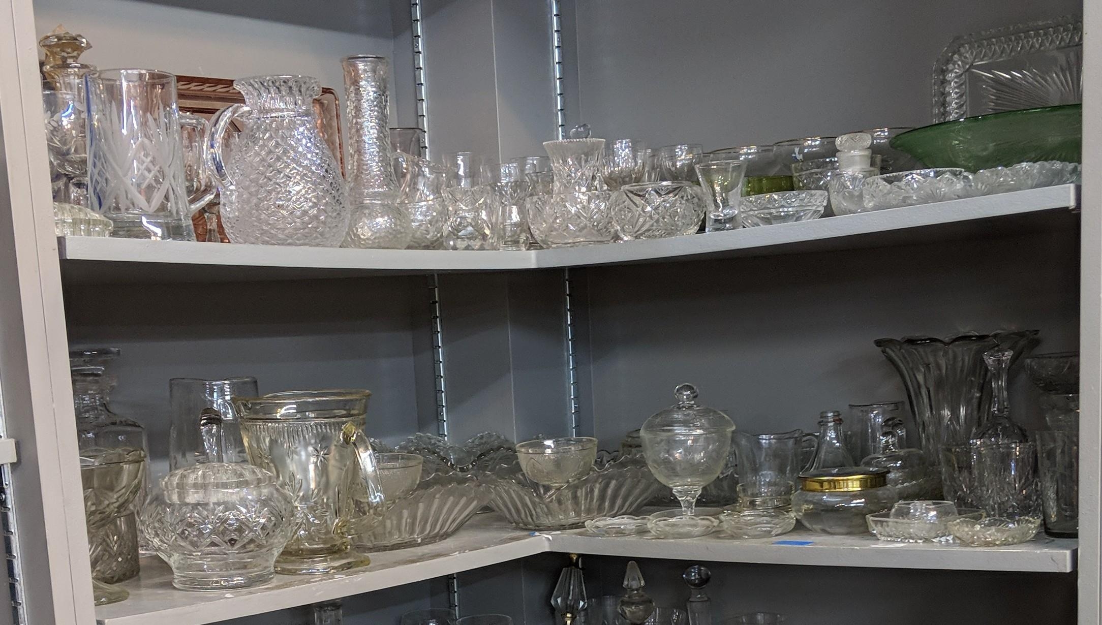 A large quantity of glassware to include domestic glasses, bowls, decanters and other items