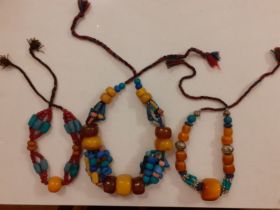 Three vintage Tibetan butterscotch amber and multi-coloured bead necklaces. Location:Cab