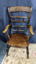 A 19th century elm seated Windsor bar back armchair having turned spindle supports Location: