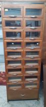 An early to mid 20th Century 18 double glazed fronted drawer haberdashery cabinet with large