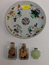 Three snuff bottles, two glass and one jade coloured and a 19th century Chinese plate decorated with