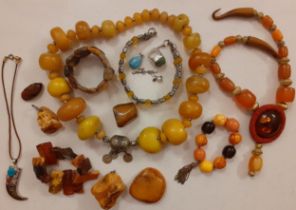 A vintage Tibetan yellow amber effect necklace having 35 irregular beads with intermittent silver