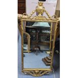 A mid 20th century French style gilt wall hanging mirror having an urn shaped finial with floral
