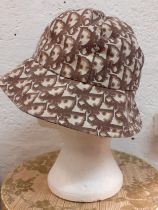Christian Dior-An early 1980's cotton bucket hat having a cream ground with branded designer name
