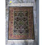 A small Persian silk woven wall hanging rug, floral design on a blue ground, triple guard border,