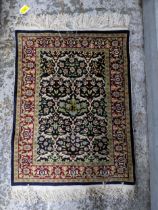 A small Persian silk woven wall hanging rug, floral design on a blue ground, triple guard border,