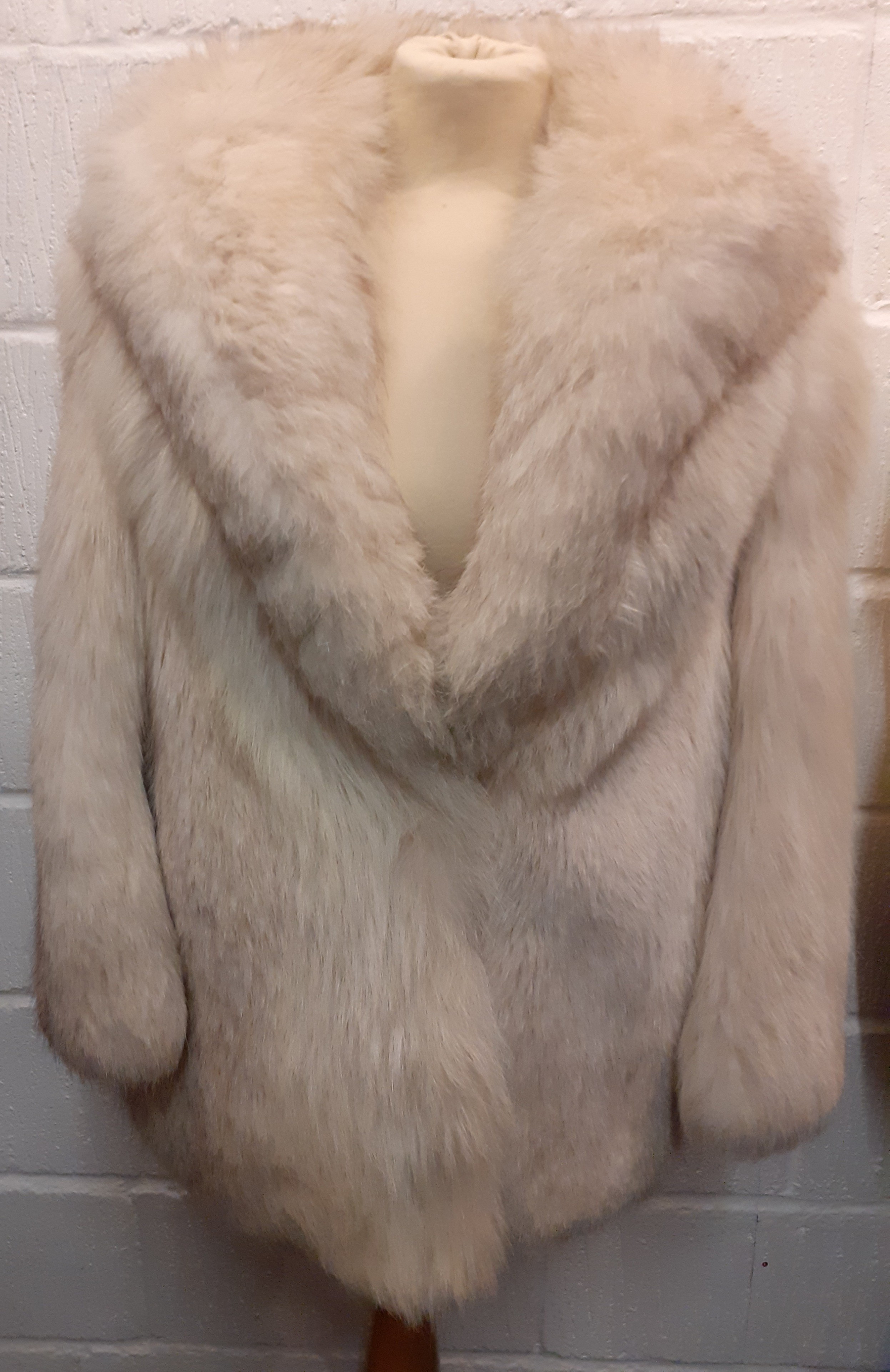 A late 20th Century arctic fox jacket having a shawl collar and a brown satin lining, approx 38"