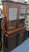 A Victorian mahogany bookcase having glazed doors above two drawers and panelled doors 177cm h x