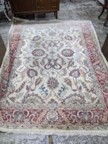 A contemporary hand woven Afgan Zeigler rug, all over floral pattern on a sandy coloured ground,