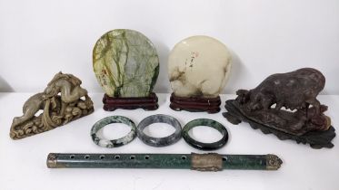 A mixed lot to include soapstone, carved sculptures, jade bangles and other items Location: