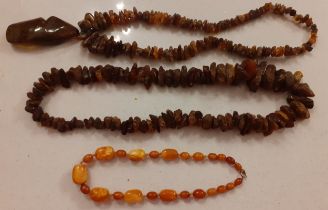 Three vintage amber necklaces to include 2 rough brown amber necklaces and an egg yolk