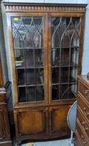 A reproduction mahogany display cabinet, twin astragal glazed doors and sides, internal shelves,