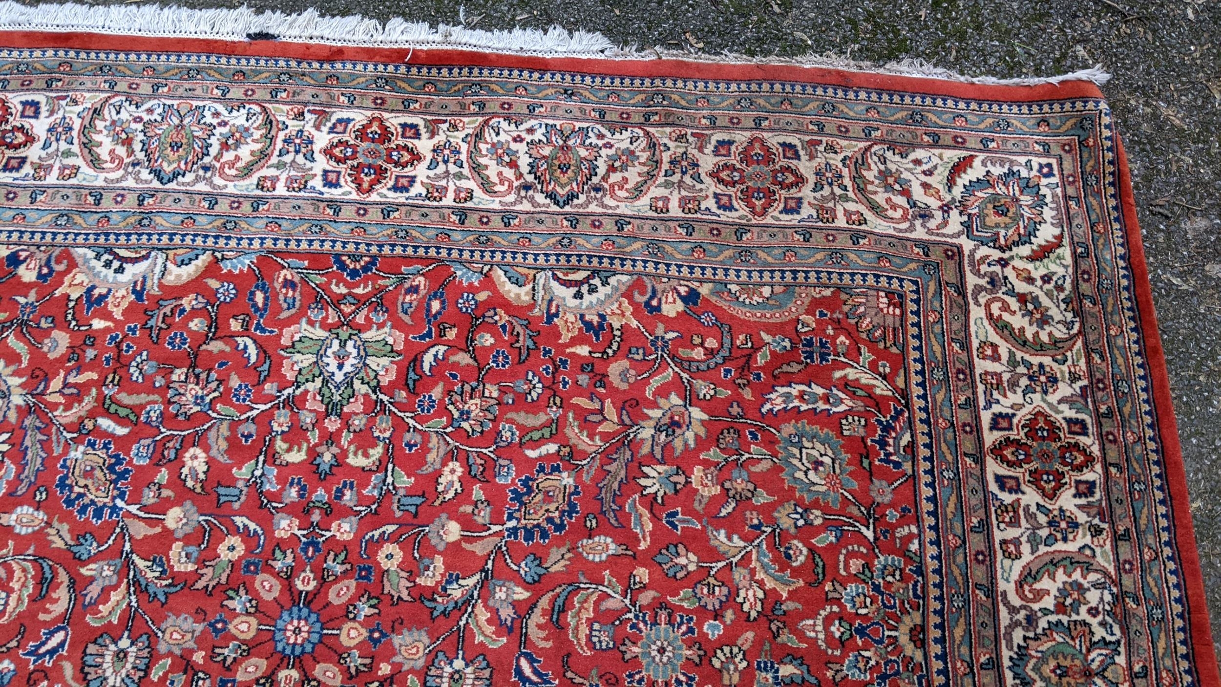 Persian hand woven rug having a red ground with a floral design multiguard borders and tasselled - Image 6 of 8
