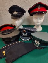 A group of service hats to include a mid 20th Century British Military Army Officer's visor cap