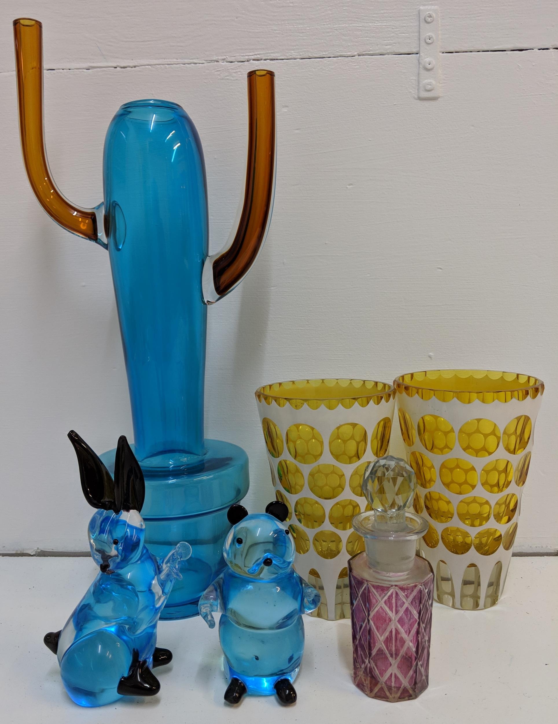 A Conran blue glass vase (signed), two yellow decoratively designed drinking glass, a pink glass