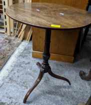 A Georgian mahogany snap top occasional table, circular top supported on turned column on three