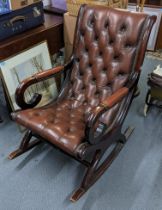 A reproduction mahogany button back slipper rocking chair Location: