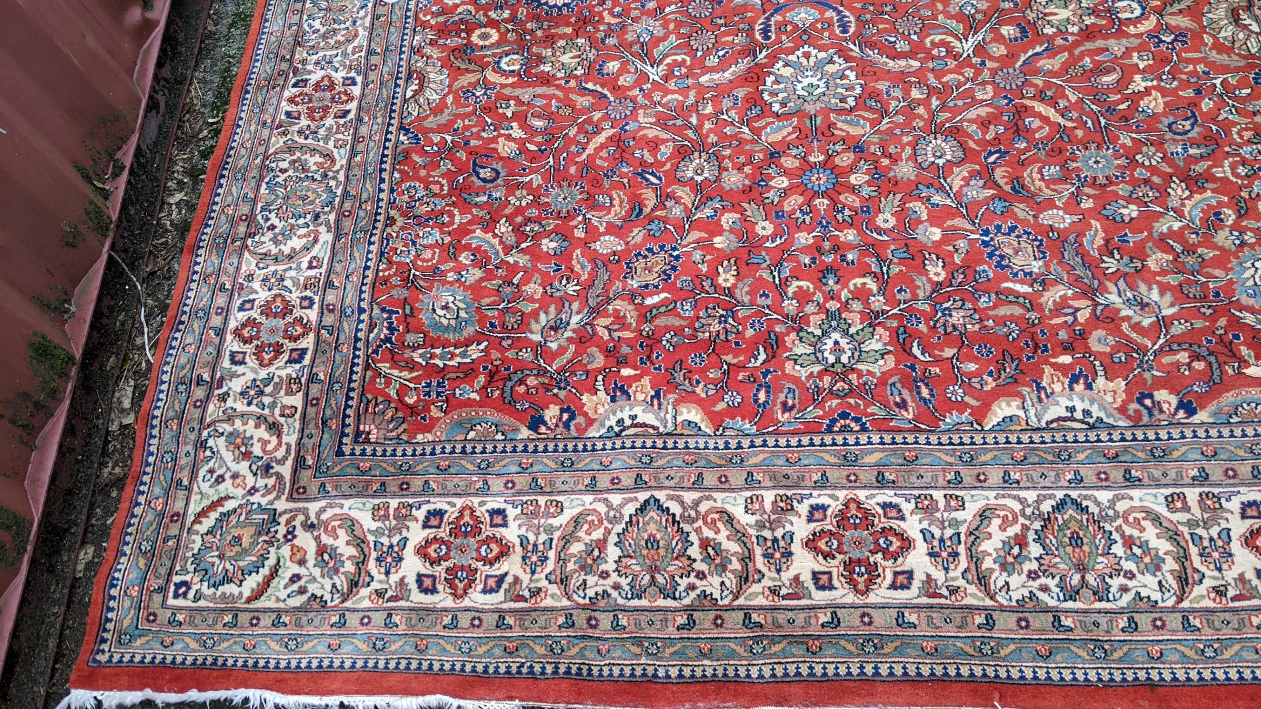 Persian hand woven rug having a red ground with a floral design multiguard borders and tasselled - Image 3 of 8