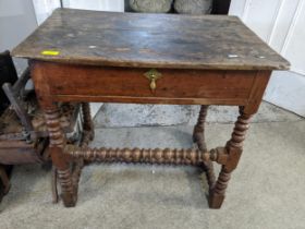 A Georgian mixed wood lowboy, single drawer with brass handle, on bobbin turned and block legs and