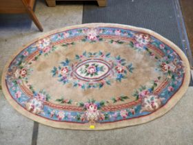 A late 20th century Chinese oval rug, floral pattern on a beige and blue ground 205cm x 123cm