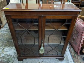 A mahogany glazed bookcase with shaped 3/4 gallery top, twin astragal glazed doors, internal