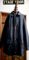 Burberrys- A 1980's/1990's gents navy waterproof jacket with iconic tartan lining, press stud and