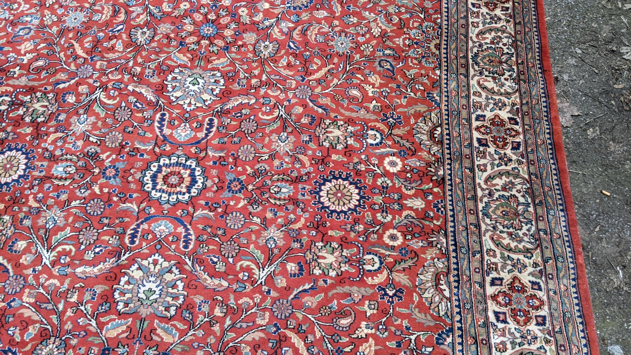 Persian hand woven rug having a red ground with a floral design multiguard borders and tasselled - Image 5 of 8