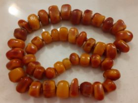 A vintage hand carved amber necklace having 46 irregular beads measuring 100cm in length in total.