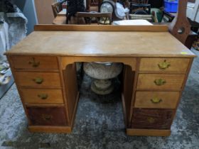 Early 20th century light oak and pine kneehole desk, extended back, four graduated drawers to each