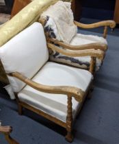 A pair of early 20th century Continental armchairs having scrolled arms, barley twist supports and