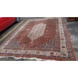 A Persian handwoven carpet having a red ground with a central motif and geometric design 434x331 (