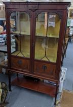 An Edwardian mahogany display bookcase having a dental moulded cornice, two glazed doors, and open