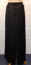 Christian Dior-A pair of black woollen wide leg trousers with silk lining, UK size 8, serial