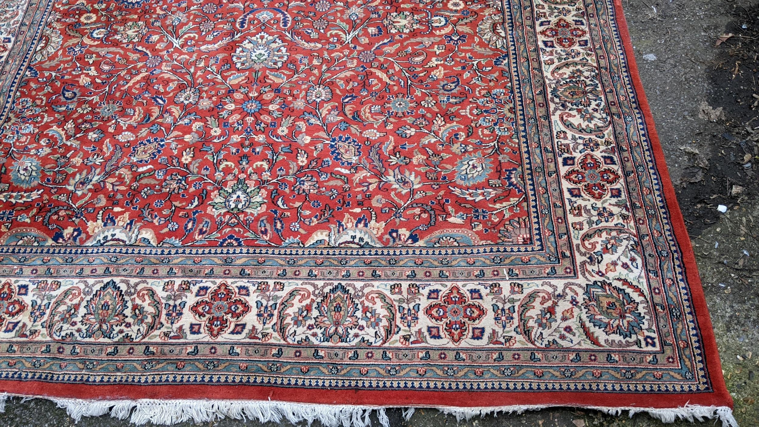 Persian hand woven rug having a red ground with a floral design multiguard borders and tasselled - Image 2 of 8