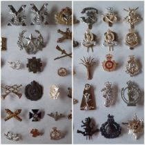A collection of military cap badges to include The Somerset Light Infantry (Prince Albert's Own) cap