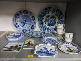A collection of Delft pottery to include wall chargers, plates and tiles, along with Royal Doulton