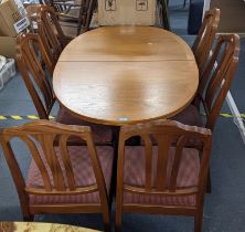 A mid 20th century Parker Knoll teak extending dining table 75hx135w together with six matching