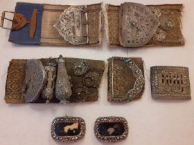 A collection of 19th Century Yemeni partial belts decorated with embossed and pierced buckles,