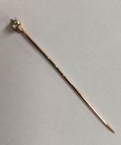 A gold stick pin, set with a diamond 0.2ct, 1.3g Location: