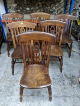 A set of six Windsor chairs with pierced centre splat, elm seat, on turned legs and double H-