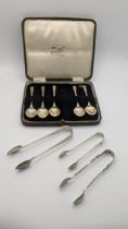 A cased set of five teaspoons together with two pairs of silver sugar tongs, 95.8g, along with