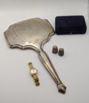 A silver dressing table mirror together with two embossed thimbles and a ladies Tissot manual wind