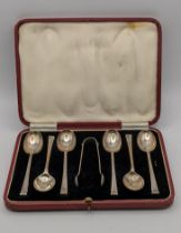 A boxed set of six table spoons along with a pair of sugar tongs hallmarked Sheffield 1938, 120.4g