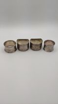 A pair of silver napkin rings together with two others, total weight 98.2g Location: