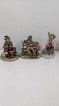 Three Capodimonte porcelain figurines to include a Tramp frying sausages with a dog, two others, one