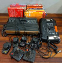 Vintage video games consoles to include Atari II games and controllers and an Interstate console