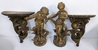 A pair of late 19th century cast spelter figures together with a pair of giltwood carved wall