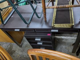 A contemporary leather topped and metal framed two drawer desk, with matching three drawer filing