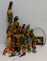 A collection of mostly wooden model parrots perched on various items, largest 77cm h Location: