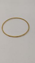 A 22ct gold bangle having engraved textured design 7.5g Location